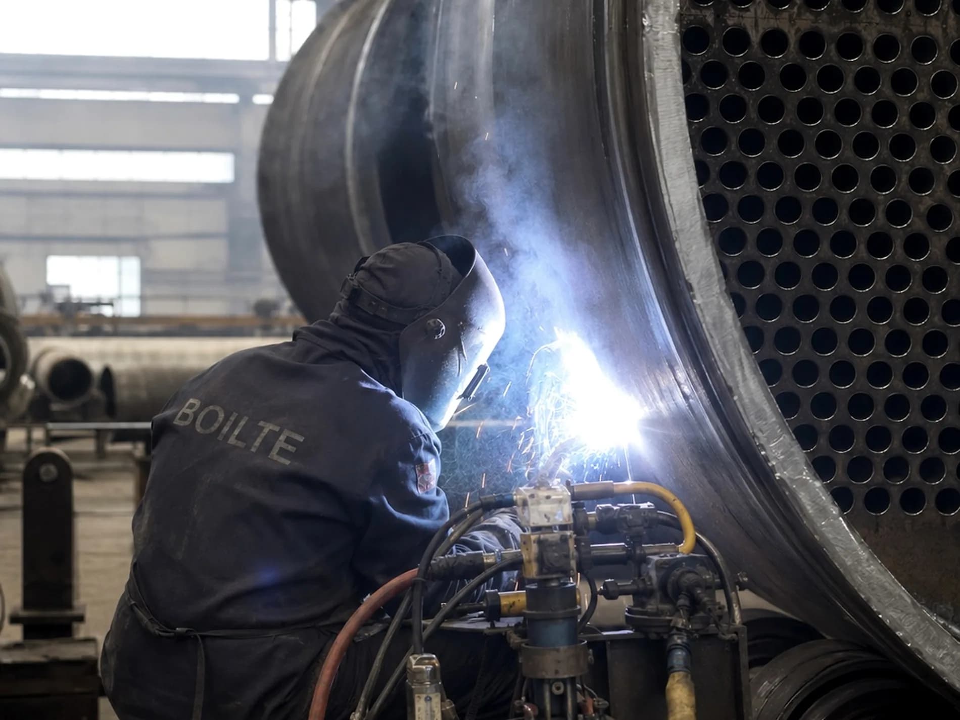Boilte welder running a seam on the boiler shell