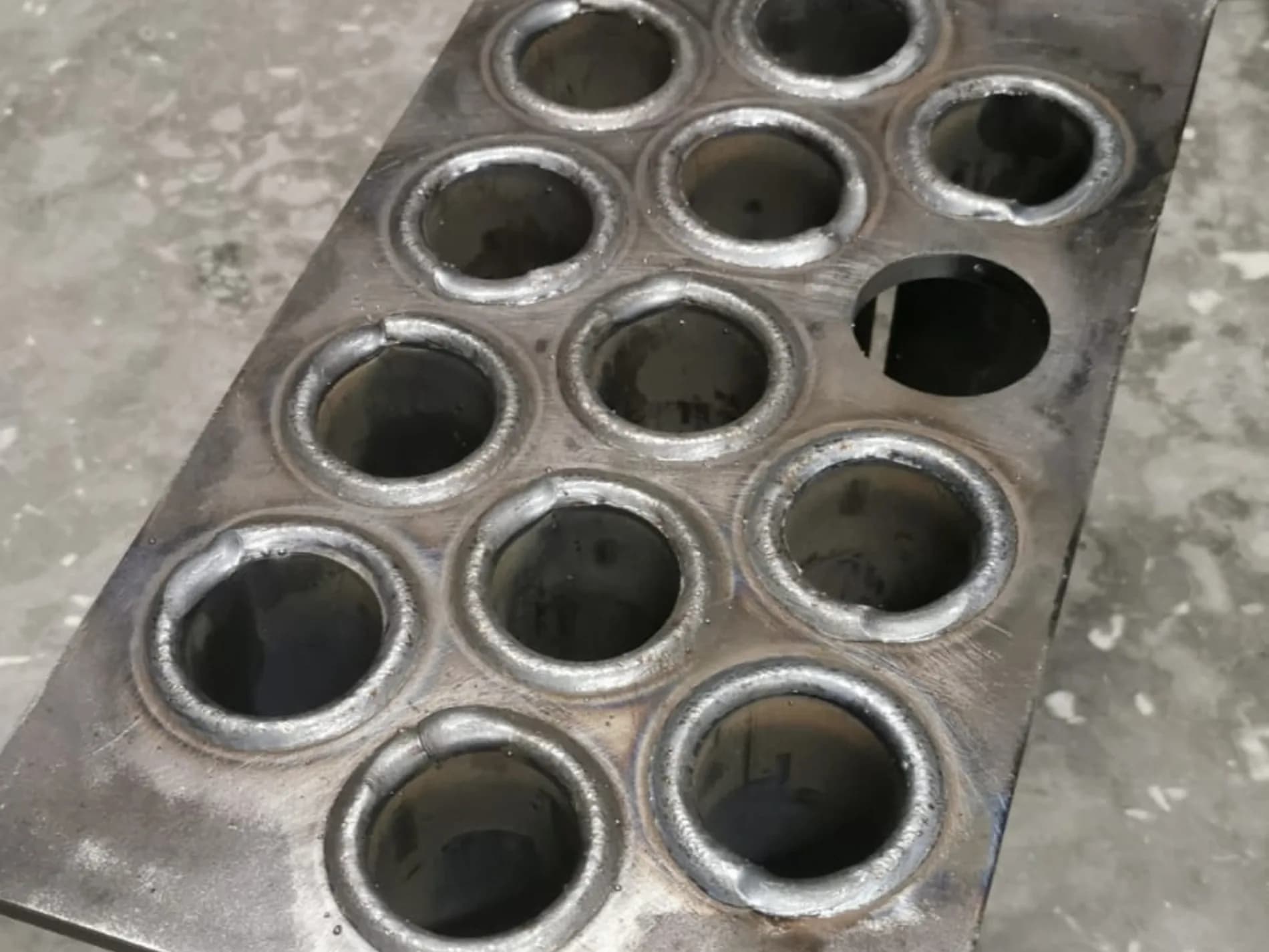 Close-up of expanded tube ends in the tube sheet